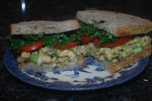 faux chicken salad sandwich with tomato and kale